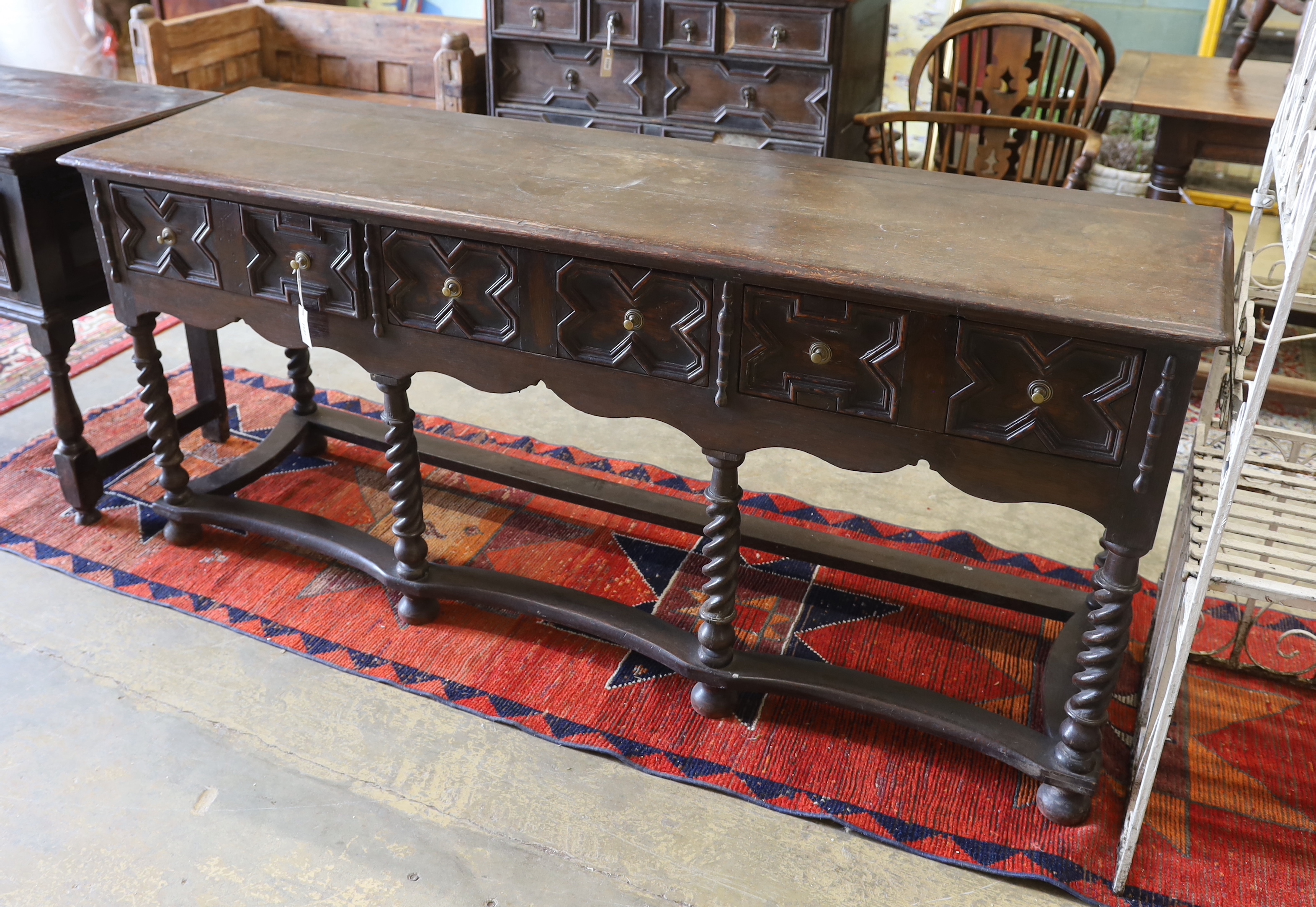 An 18th century style oak three drawer low dresser on spiral turned legs, incorporates old timber, width 190cm, depth 52cm, height 84cm